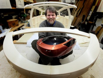 PHIL.HOSSACK@FREEPRESS.MB.CA 101220-Winnipeg Free Press Holding a 1/4 scale replica, Jim Kor sits in plastic body panels for his electric car "Urban". Panels are "printed" with a 3D printer out of plastic for the vehicle....Murray's tale.