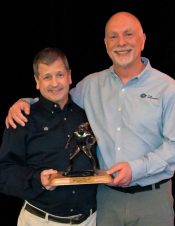 Gary Rabinovitz (left) receiving AMUG's Lifetime Achievement Award from Paul Bates.